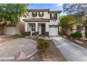 Inviting two-story home with a tile roof, a private porch, and low-maintenance desert landscaping at 6343 W Sophie Ln, Laveen, AZ 85339