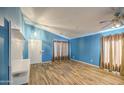 Spacious living room featuring wood floors, high ceilings, and ample natural light at 6428 W Cordes Rd, Phoenix, AZ 85043