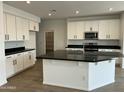 Bright eat-in kitchen featuring modern stainless steel appliances and granite countertops at 7433 W Rovey Ave, Glendale, AZ 85303