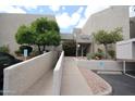 Building exterior with a handicap ramp that leads to the entrance of the condo at 7474 E Earll Dr # 201, Scottsdale, AZ 85251