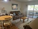 Living room with wood floors, comfy seating, area rug and access to an outdoor patio at 7474 E Earll Dr # 201, Scottsdale, AZ 85251