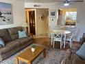 Comfortable living room with hardwood floors, ceiling fan and open access to the kitchen at 7474 E Earll Dr # 201, Scottsdale, AZ 85251