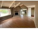 Bright living room with brick fireplace and hardwood floors at 836 W Laguna Azul Ave, Mesa, AZ 85210