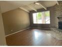 Bright living room with brick fireplace and hardwood floors at 836 W Laguna Azul Ave, Mesa, AZ 85210