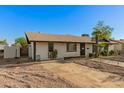 A charming single-story home with desert landscaping and mature trees in a residential neighborhood at 8717 W Turney Ave, Phoenix, AZ 85037