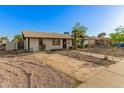 A charming single-story home with desert landscaping and mature trees in a residential neighborhood at 8717 W Turney Ave, Phoenix, AZ 85037