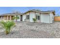 Inviting single-story home with desert landscaping, solar panels, and a quaint covered entryway at 8930 W Sells Dr, Phoenix, AZ 85037