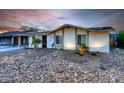 Charming single-story home featuring desert landscaping, solar panels, and a covered carport at 8930 W Sells Dr, Phoenix, AZ 85037