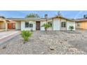 Well-maintained single-story home with desert landscaping, solar panels, and a cozy front entrance at 8930 W Sells Dr, Phoenix, AZ 85037