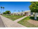 Pleasant street view showcasing multiple homes with well-kept lawns and mature trees at 10072 W Lancaster Dr, Sun City, AZ 85351