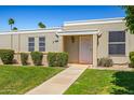 Charming home featuring a walkway to the front door, complemented by green grass and small bushes at 10072 W Lancaster Dr, Sun City, AZ 85351