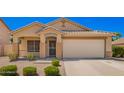 Charming single-story home featuring a tile roof, desert landscaping and a spacious two car garage at 1071 E Chelsea Dr, San Tan Valley, AZ 85140