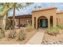 Front exterior featuring desert landscaping, a tile roof and a light-blue front door at 11051 N 45Th Pl, Phoenix, AZ 85028