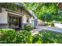 Inviting front porch with lush greenery and cozy seating, offering a welcoming entrance to the home at 1140 E Vermont Dr, Gilbert, AZ 85295
