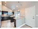 Bright kitchen featuring modern appliances, dark cabinets, and a convenient breakfast bar at 1147 E Belmont Ave, Phoenix, AZ 85020