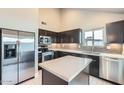 Well-lit kitchen showcasing stainless steel appliances, sleek cabinetry, and a stylish island at 1147 E Belmont Ave, Phoenix, AZ 85020