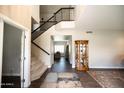 Bright foyer with hardwood floors, staircase, and elegant decor at 1374 N Alexis Dr, Gilbert, AZ 85234