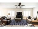 Cozy living room featuring a ceiling fan, modern TV, and comfortable seating at 1374 N Alexis Dr, Gilbert, AZ 85234