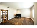 Comfortable living room featuring a piano, hardwood floors, and warm lighting at 1374 N Alexis Dr, Gilbert, AZ 85234