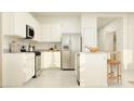 Modern kitchen with stainless steel appliances, white cabinets, and granite countertops with a center island at 17375 W Whispering Wind Rd, Surprise, AZ 85387