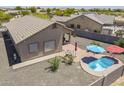 Aerial view of the pool, brick patio, and outdoor space of this residential home at 1813 N Lewis Pl, Casa Grande, AZ 85122