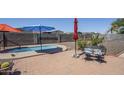 Backyard features a relaxing spa and a seating area perfect for entertaining guests at 1813 N Lewis Pl, Casa Grande, AZ 85122