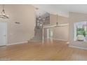 Spacious living room featuring hardwood floors, a staircase and high ceilings at 1898 E Kent Ave, Chandler, AZ 85225