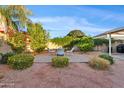 Private backyard patio with pavers, desert landscaping, and mature trees for relaxing outdoor living at 22274 E Cherrywood Ct, Queen Creek, AZ 85142