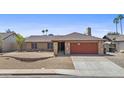 Inviting single story home featuring a two-car garage and desert landscaping for easy maintenance at 2247 W Highland St, Chandler, AZ 85224