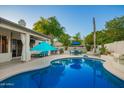 Gorgeous backyard oasis with a sparkling pool and ample seating areas for entertaining at 2406 E Oakland St, Chandler, AZ 85225