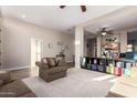 Spacious living room with a seamless blend of carpet and tile flooring, and ample seating at 2406 E Oakland St, Chandler, AZ 85225