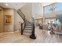 Grand foyer showcasing a curved staircase, high ceilings, and an open view into the living and dining areas at 2454 W Hope Cir, Chandler, AZ 85248