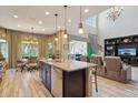 Open-concept kitchen with a large island, granite countertops, stainless steel appliances, and seamless flow to the living area at 2454 W Hope Cir, Chandler, AZ 85248