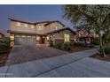 Inviting exterior view of a two-story home with a double garage and well-maintained landscaping at 2557 N Springfield St, Buckeye, AZ 85396