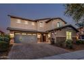 Stunning home with a spacious driveway and a manicured front yard with an American flag at 2557 N Springfield St, Buckeye, AZ 85396