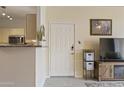 Bright entryway next to the kitchen, and featuring a door and television at 29606 N Tatum Blvd # 174, Cave Creek, AZ 85331