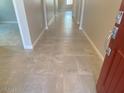 Welcoming entryway featuring neutral walls, tile flooring, and a vibrant red front door creating a warm first impression at 31619 N Shady Pasture Ln, San Tan Valley, AZ 85143