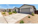 Charming single-story home featuring a well-maintained lawn, neutral stucco facade, and attached two-car garage at 31619 N Shady Pasture Ln, San Tan Valley, AZ 85143