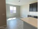 Bright kitchen with a light countertop island, stainless steel appliances, and seamless flow into the adjacent living area at 31619 N Shady Pasture Ln, San Tan Valley, AZ 85143