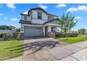 Inviting home exterior with a brick driveway, lush lawn, and manicured landscaping at 3415 E Arabian Dr, Gilbert, AZ 85296
