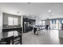 Spacious living area featuring an open floor plan and seamless integration with the modern kitchen at 42180 W Cheyenne Dr, Maricopa, AZ 85138