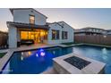 A luxurious backyard with a pristine pool, a cozy fire pit, and a covered patio at 4337 S Helix --, Mesa, AZ 85212