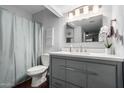 Updated bathroom with gray vanity, modern fixtures, and shower-tub combination at 4554 E Paradise Village Pkwy # 267, Phoenix, AZ 85032