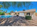 Spacious backyard with a sparkling pool, mature trees, and a covered patio perfect for outdoor entertaining at 4815 E Everett Dr, Scottsdale, AZ 85254