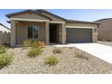 Charming single-story home with a gray two-car garage and low-maintenance desert landscaping at 5533 N 193Rd Ave, Litchfield Park, AZ 85340