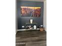 Modern decor highlights the living room, featuring gray accent wall, console table, and wood-look flooring at 6421 S 23Rd Dr, Phoenix, AZ 85041
