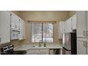 Bright kitchen featuring white cabinetry, modern appliances, and a window offering natural light at 6722 W Shannon St, Chandler, AZ 85226