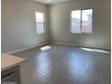 Bright living room with tile flooring and two windows allowing an abundance of natural light at 7209 E Blissful Breeze Ln, San Tan Valley, AZ 85143