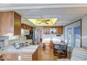 Well-lit kitchen featuring wood cabinets, white appliances, and a cozy breakfast nook at 7750 E Broadway Rd # 361, Mesa, AZ 85208