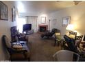 Cozy living room with a brick fireplace, comfortable seating, and neutral carpeting at 8651 E Royal Palm Rd # 118, Scottsdale, AZ 85258